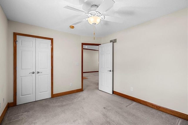 unfurnished bedroom with baseboards, visible vents, a closet, and carpet
