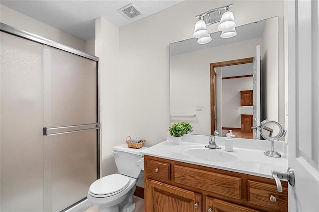 full bathroom with vanity, visible vents, toilet, and a shower stall