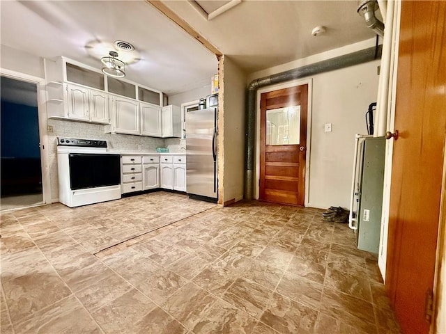 611 E Elm St, Hardin, MO 64035 - kitchen with range with electric cooktop, stainless steel refrigerator, white cabinetry, light countertops, and tasteful backsplash