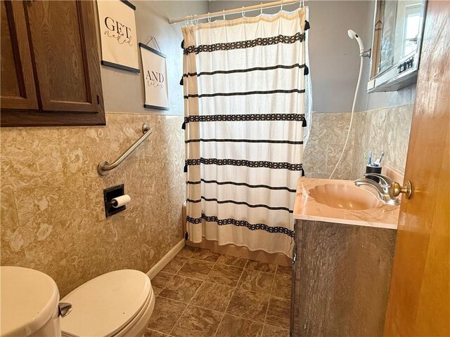 611 E Elm St, Hardin, MO 64035 - bathroom featuring vanity, a shower with shower curtain, and tile walls
