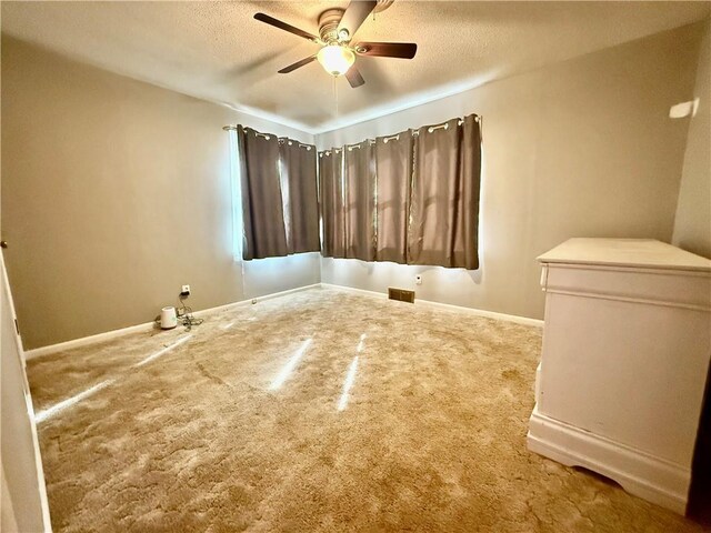 611 E Elm St, Hardin, MO 64035 - carpeted spare room with ceiling fan and a textured ceiling
