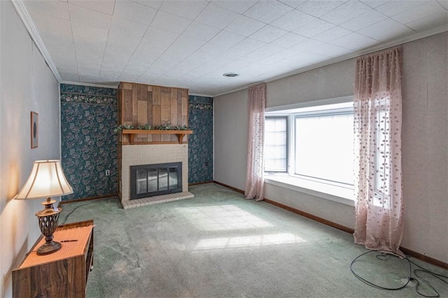 unfurnished living room with baseboards, crown molding, carpet, and a brick fireplace