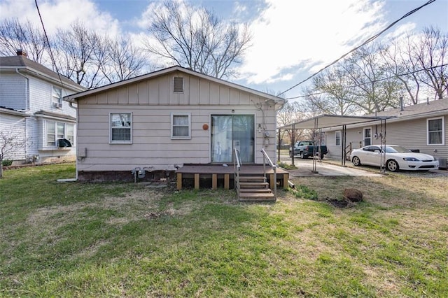 rear view of property with board and batten siding and a yard
