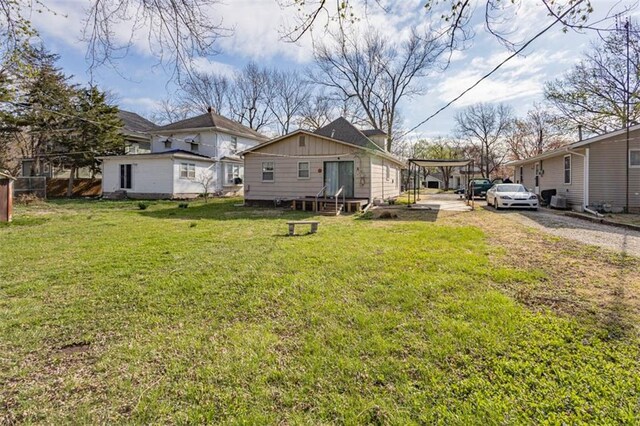 back of property with board and batten siding and a lawn