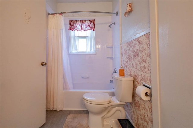 full bathroom featuring toilet and shower / bath combo with shower curtain