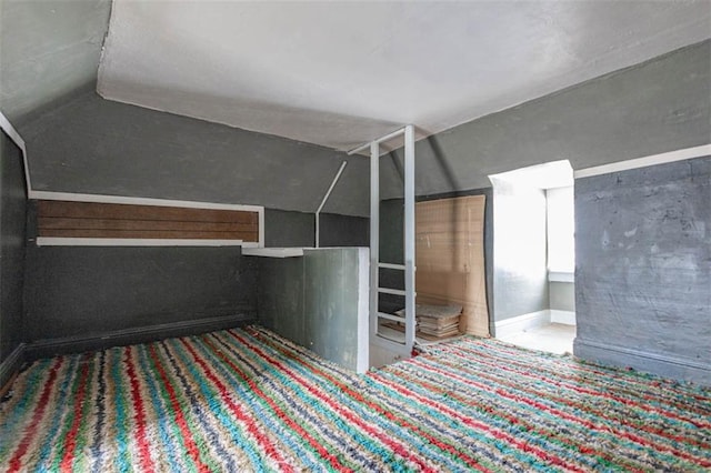 unfurnished bedroom featuring lofted ceiling