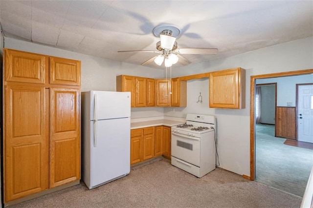 kitchen with light countertops, a ceiling fan, light colored carpet, and white appliances