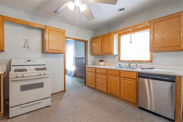 kitchen featuring a sink, white gas range, dishwasher, and a healthy amount of sunlight