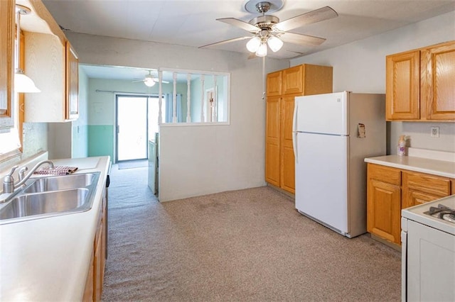 kitchen with light colored carpet, light countertops, a sink, a ceiling fan, and white appliances