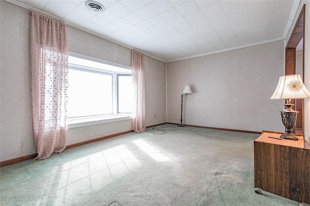 interior space with baseboards, crown molding, carpet, and visible vents