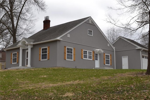 660 Elmdale, Chillicothe, MO 64601 - back of property featuring an attached garage, a yard, and a chimney
