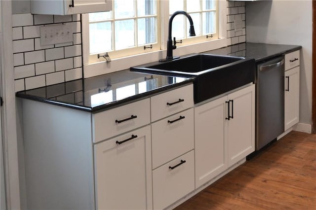 660 Elmdale, Chillicothe, MO 64601 - kitchen featuring a sink, stainless steel dishwasher, dark countertops, and wood finished floors