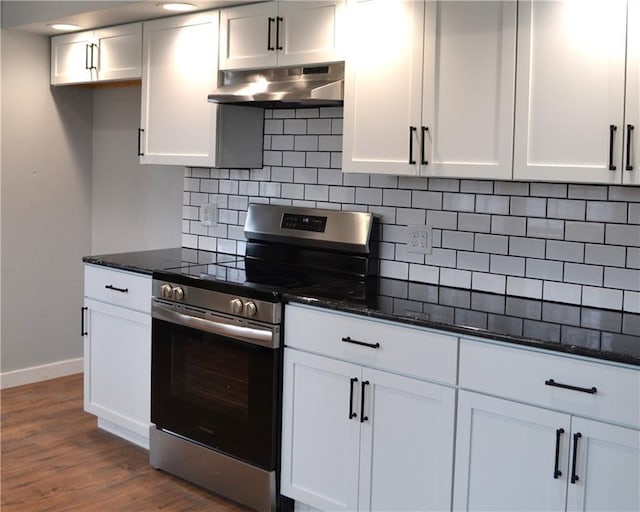 660 Elmdale, Chillicothe, MO 64601 - kitchen featuring under cabinet range hood, electric range, and dark stone counters