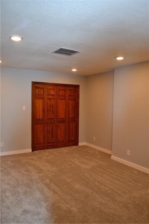 660 Elmdale, Chillicothe, MO 64601 - interior space featuring visible vents, a textured ceiling, recessed lighting, baseboards, and light colored carpet