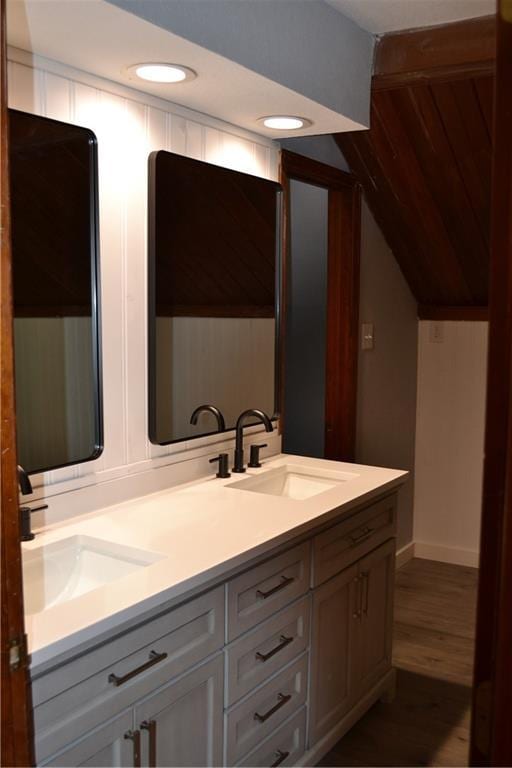 660 Elmdale, Chillicothe, MO 64601 - bathroom featuring a sink, lofted ceiling, wood finished floors, and double vanity