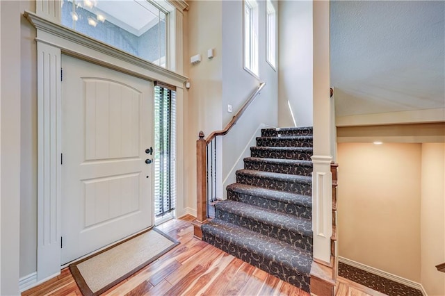 entryway featuring wood finished floors and stairs