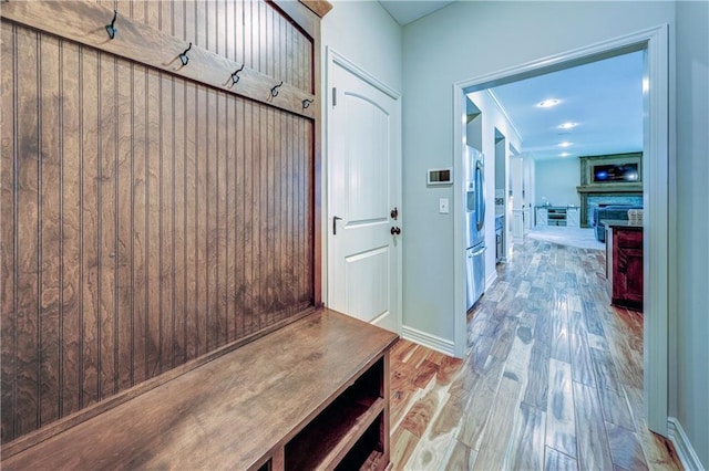 mudroom featuring wood finished floors and baseboards