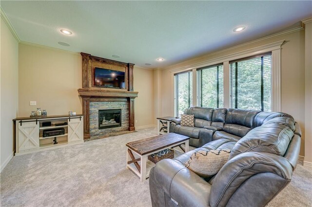 living room featuring carpet, crown molding, a stone fireplace, recessed lighting, and baseboards