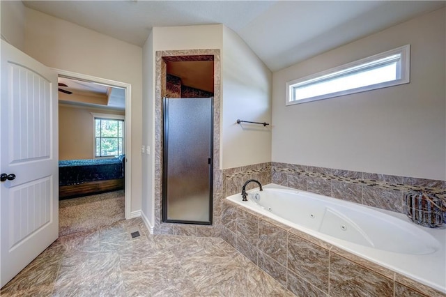 bathroom featuring healthy amount of natural light, a shower stall, and a whirlpool tub