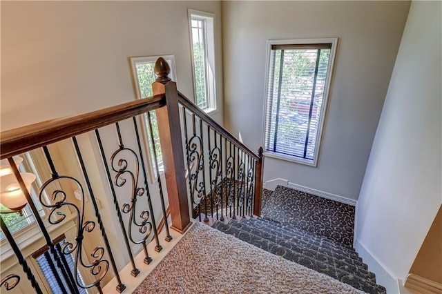 stairs featuring carpet and baseboards