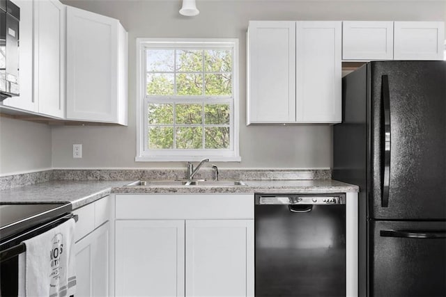 1758 Main St, Osawatomie, KS 66064 - kitchen featuring white cabinets, a sink, and black appliances