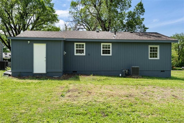 1758 Main St, Osawatomie, KS 66064 - rear view of property featuring a lawn, crawl space, a shingled roof, and central air condition unit