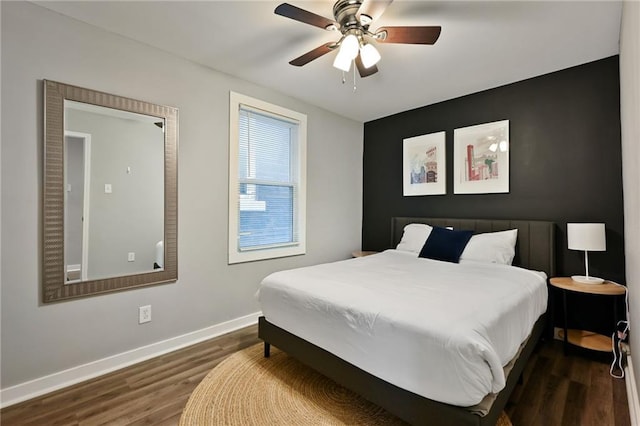 bedroom featuring dark wood finished floors, baseboards, and a ceiling fan