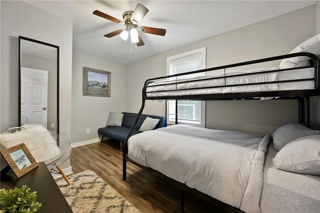 bedroom with baseboards, ceiling fan, and wood finished floors