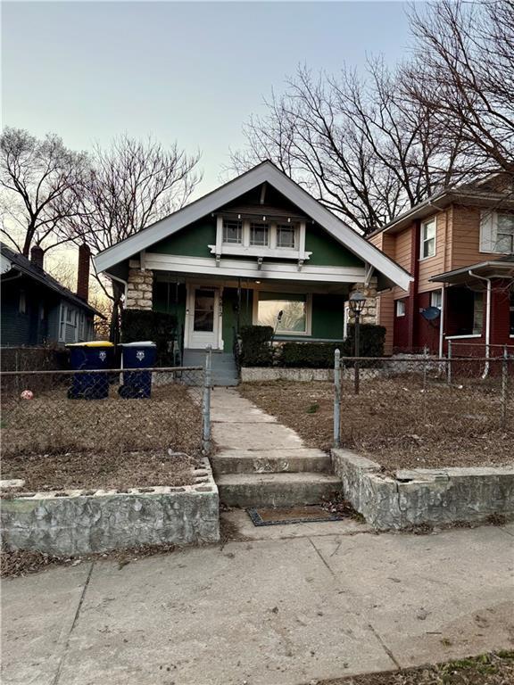3612 Bales Ave, Kansas City, MO 64128 - view of front of home with a fenced front yard and a porch