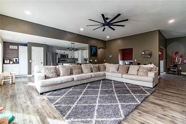 living room with recessed lighting, baseboards, ceiling fan, visible vents, and wood finished floors