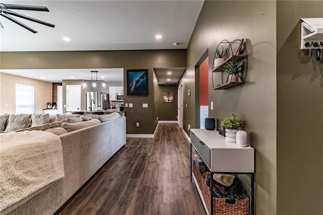 living area featuring baseboards, a ceiling fan, recessed lighting, and dark wood-style flooring