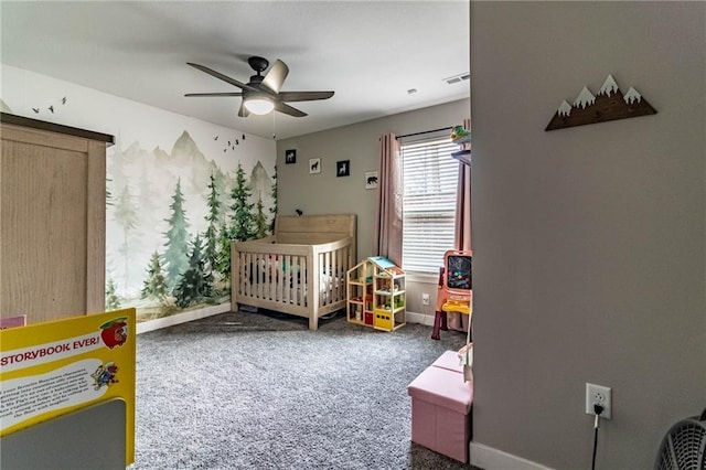bedroom with a ceiling fan, carpet flooring, baseboards, visible vents, and a crib