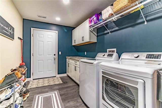 laundry room with visible vents, independent washer and dryer, baseboards, dark wood finished floors, and cabinet space