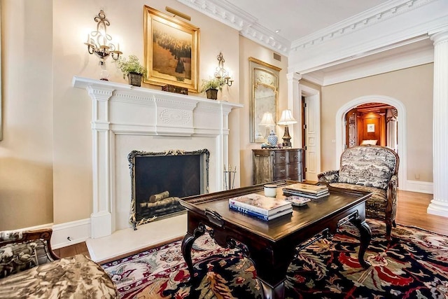 17960 S Bond St, Bucyrus, KS 66013 - sitting room featuring a fireplace, wood finished floors, arched walkways, and ornamental molding