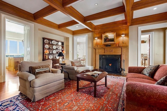17960 S Bond St, Bucyrus, KS 66013 - living room with coffered ceiling, beam ceiling, wood finished floors, a fireplace, and crown molding