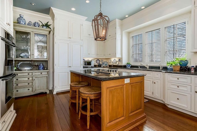 17960 S Bond St, Bucyrus, KS 66013 - kitchen featuring black electric cooktop, a chandelier, dark wood-type flooring, dark countertops, and recessed lighting