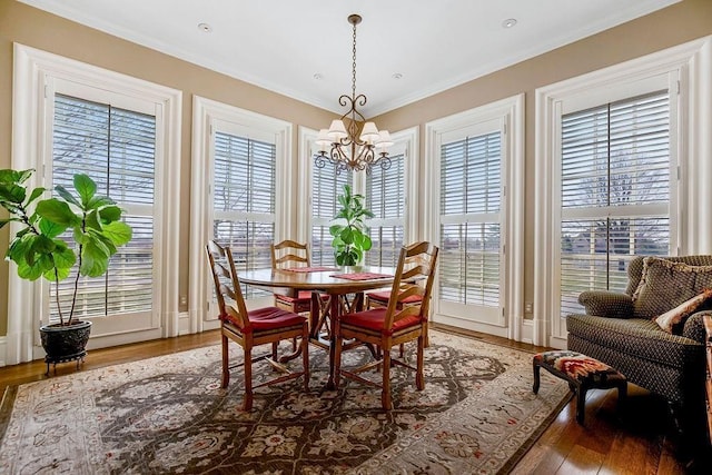 17960 S Bond St, Bucyrus, KS 66013 - dining area featuring a chandelier, wood finished floors, plenty of natural light, and ornamental molding