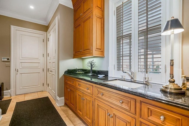 17960 S Bond St, Bucyrus, KS 66013 - kitchen featuring brown cabinets, dark stone countertops, crown molding, and light tile patterned floors