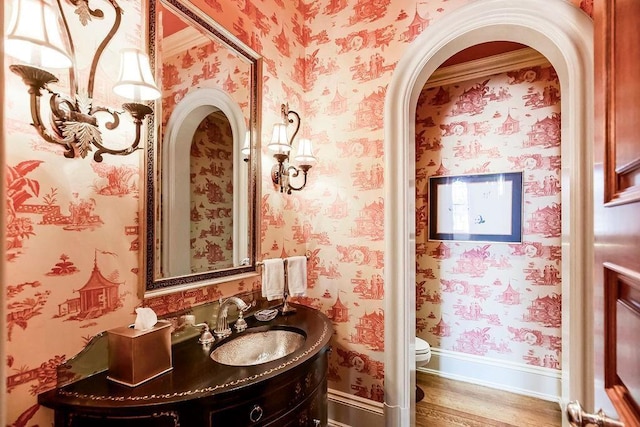 17960 S Bond St, Bucyrus, KS 66013 - bathroom with wallpapered walls, wood finished floors, and vanity