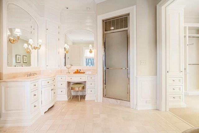 17960 S Bond St, Bucyrus, KS 66013 - full bath with double vanity, wainscoting, crown molding, tile patterned flooring, and a decorative wall