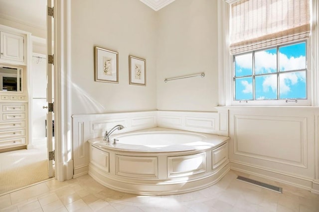 17960 S Bond St, Bucyrus, KS 66013 - full bathroom featuring a bath, a decorative wall, ornamental molding, a wainscoted wall, and tile patterned floors