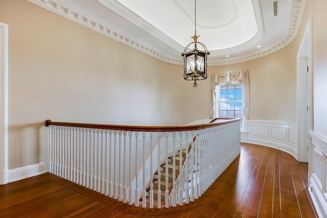 17960 S Bond St, Bucyrus, KS 66013 - corridor featuring an upstairs landing, hardwood / wood-style floors, a chandelier, a tray ceiling, and wainscoting