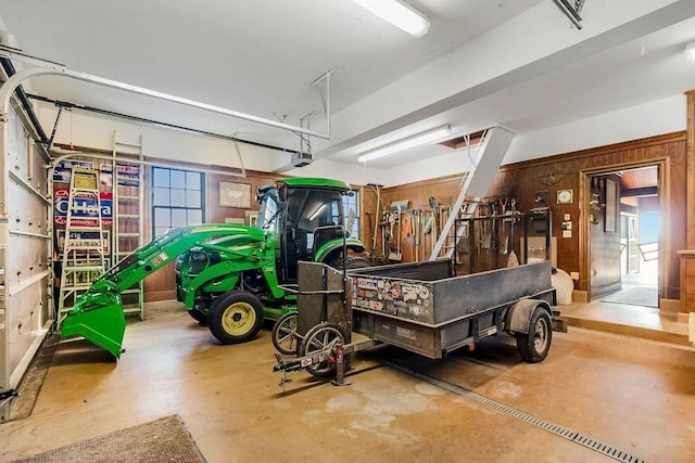 17960 S Bond St, Bucyrus, KS 66013 - garage with wood walls and a garage door opener
