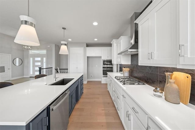 4275 Lake Shore Ct, Basehor, KS 66007 - kitchen featuring appliances with stainless steel finishes, wall chimney range hood, a sink, white cabinets, and backsplash
