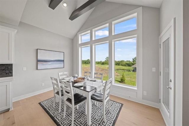 4275 Lake Shore Ct, Basehor, KS 66007 - dining room featuring light wood finished floors, high vaulted ceiling, and baseboards