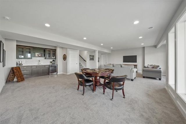 4275 Lake Shore Ct, Basehor, KS 66007 - dining room featuring beverage cooler, light carpet, bar, stairway, and recessed lighting