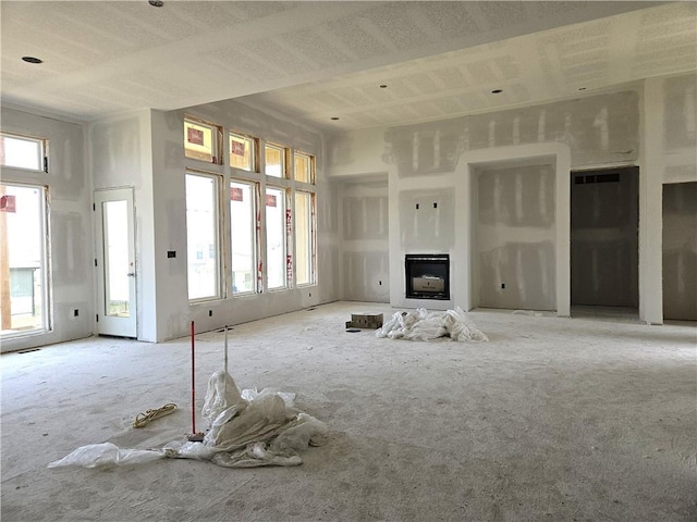 4275 Lake Shore Ct, Basehor, KS 66007 - unfurnished living room with a fireplace and carpet floors