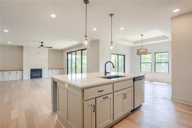 907 Reed Dr, Raymore, MO 64083 - kitchen with dishwasher, ceiling fan, plenty of natural light, a fireplace, and recessed lighting