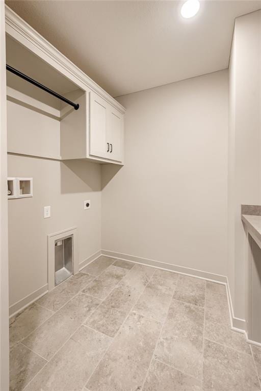 907 Reed Dr, Raymore, MO 64083 - laundry room with hookup for an electric dryer, cabinet space, and hookup for a washing machine
