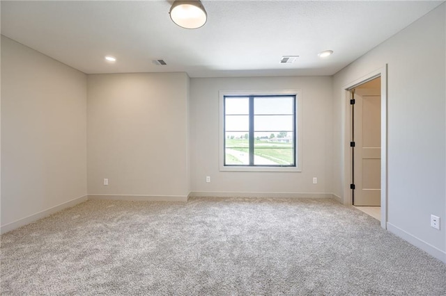 907 Reed Dr, Raymore, MO 64083 - spare room with light colored carpet and recessed lighting